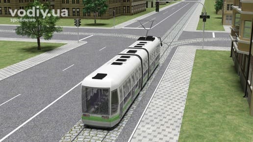 Трамвай на колії посеред дороги, спеціальне вимощення та дорожня розмітка 1.1 вздовж рейкових шляхів на перехресті.
