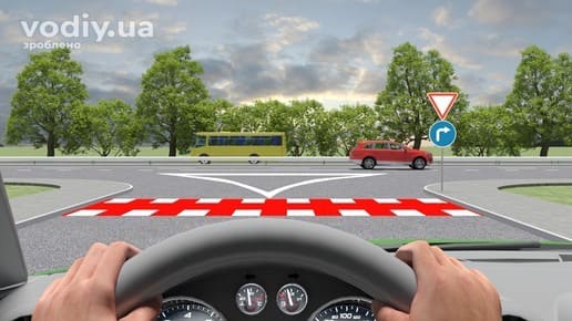 Дорожні знаки 2.1 «Дати дорогу» та 4.2 «Рух праворуч» перед Т-подібним перехрестям, червоний автомобіль та жовтий автобус на головній дорозі.