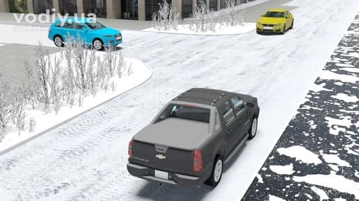 Автомобілі на засніженому перехресті без знаків пріоритету, покриття дороги неможливо визначити через сніг.