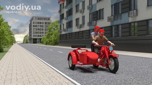 Водій та пасажир мотоцикла в мотошоломах під час руху в населеному пункті