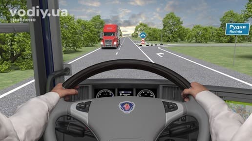 Вид з кабіни вантажівки, дорога поза населеним пунктом, дорожні знаки: 5.52 «Кінець населеного пункту», 4.7 «Об’їзд перешкоди з правого боку».