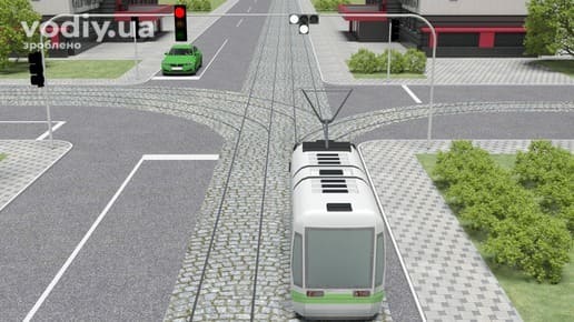 Рух трамвая на регульованому перехресті, сигнали світлофора для трамваїв біло-місячного кольору, напрямок руху трамвая по коліях.