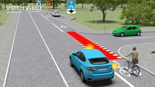 Блакитний автомобіль з увімкненим правим покажчиком повороту, велосипедист на велосипедній смузі, дорожній знак 5.88 «Велосипедна смуга».