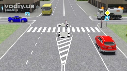 Спецтехніка з увімкненим оранжевим проблисковим маячком на перехресті, дорожні знаки: 2.3 «Головна дорога», 5.38.1 «Пішохідний перехід».