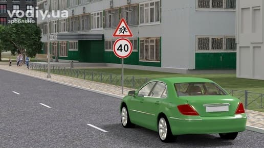 Зелений автомобіль біля школи, дорожні знаки 1.33 «Діти» та 3.29 «Обмеження максимальної швидкості» 40 км/год.