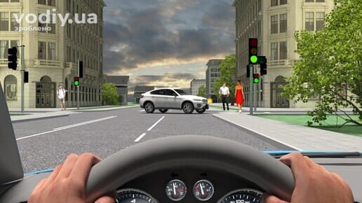 Рух прямо на зелений сигнал світлофора, зустрічний автомобіль перегородив смугу руху, пішоходи на пішохідному переході.