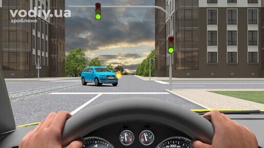 Проїзд регульованого перехрестя, зелений сигнал світлофора, зустрічний автомобіль повертає ліворуч, безпека дорожнього руху