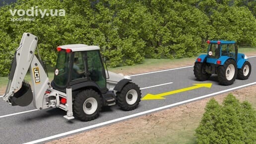 Два трактори рухаються дорогою поза населеним пунктом, жовта стрілка вказує на дистанцію між ними.