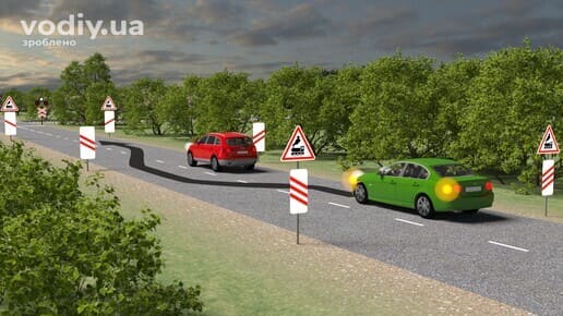 Обгін перед залізничним переїздом, дорожні знаки 1.28, 1.31.1, 1.31.2, 1.31.3, зелений автомобіль з увімкненим покажчиком повороту та червоне авто.