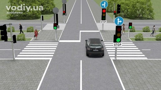 Автомобіль на перехресті, дорожні знаки 4.4, 5.69, розмітка 1.12 (стоп-лінія) та червоний сигнал світлофора на виїзді.